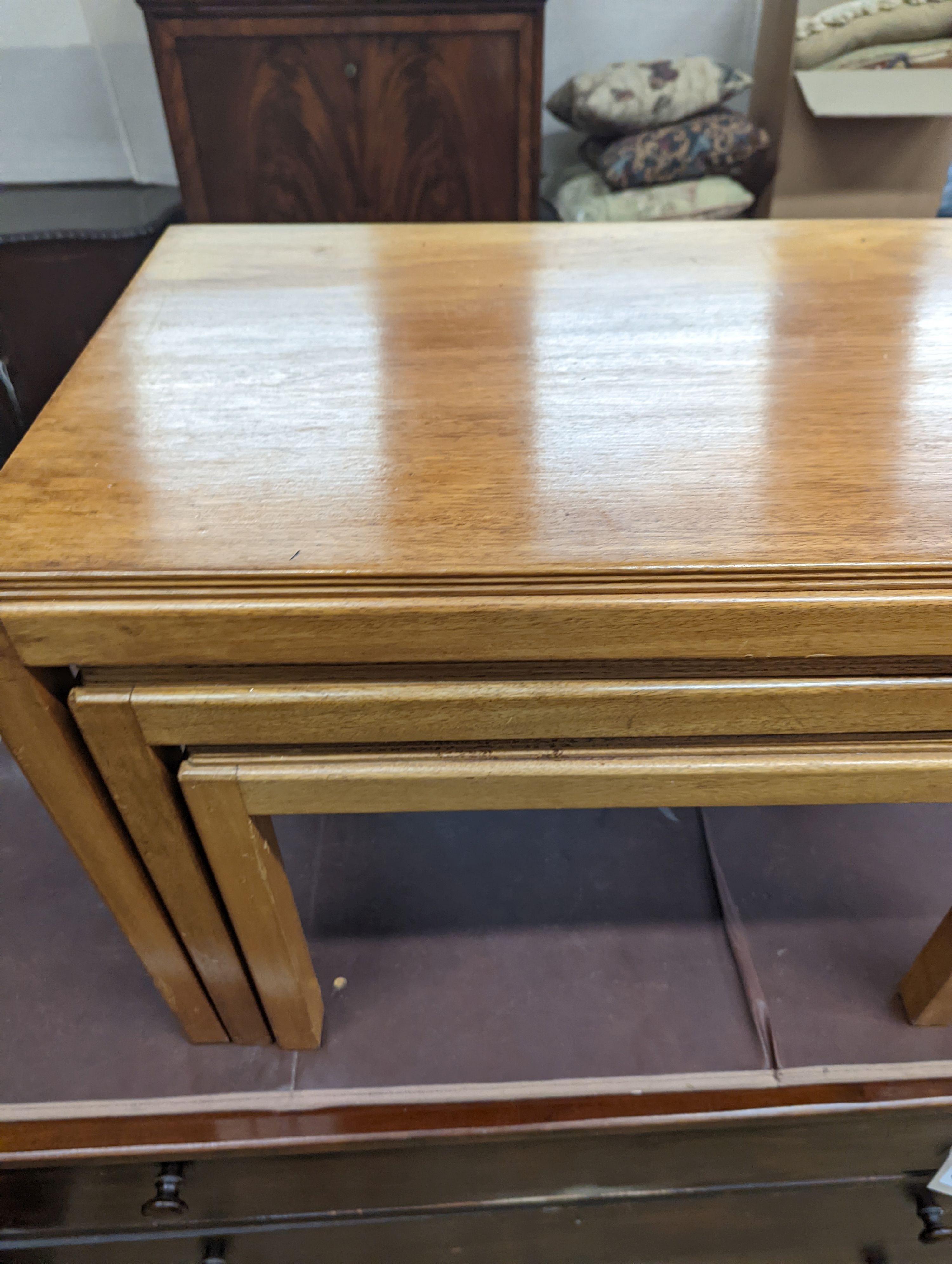 A nest of three Gordon Russell 1960's rectangular teak tea tables, width 68cm, depth 45cm, height 46cm
